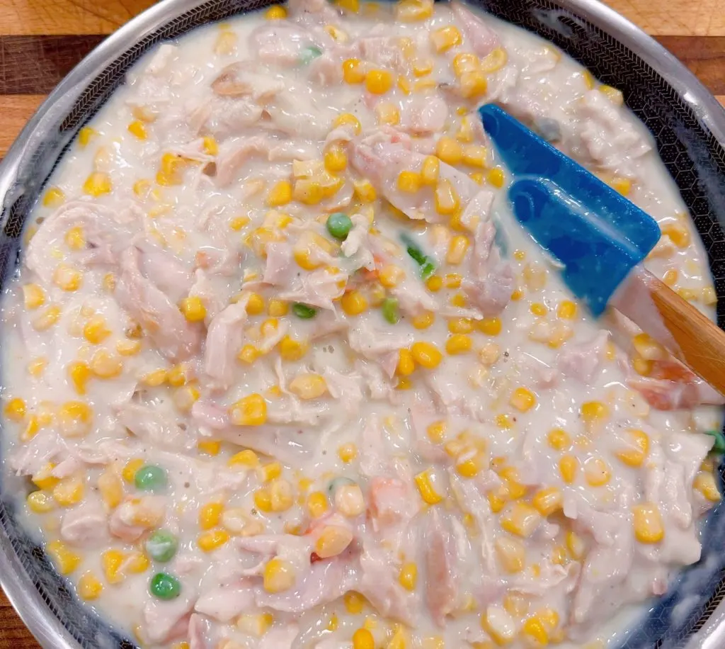 Adding in other vegetables to the cream mixture.