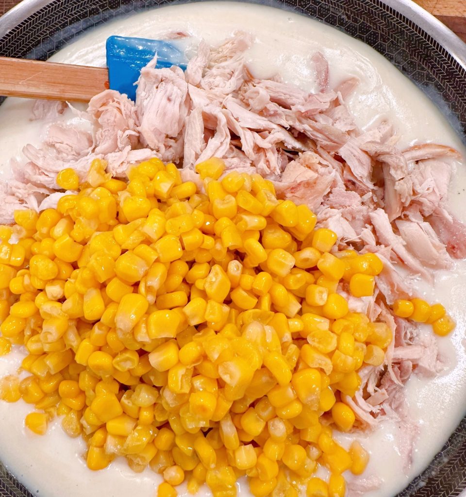 Add chicken and corn to the white sauce.