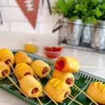 Easy two ingredients mini corn dogs with mustard and ketchup.