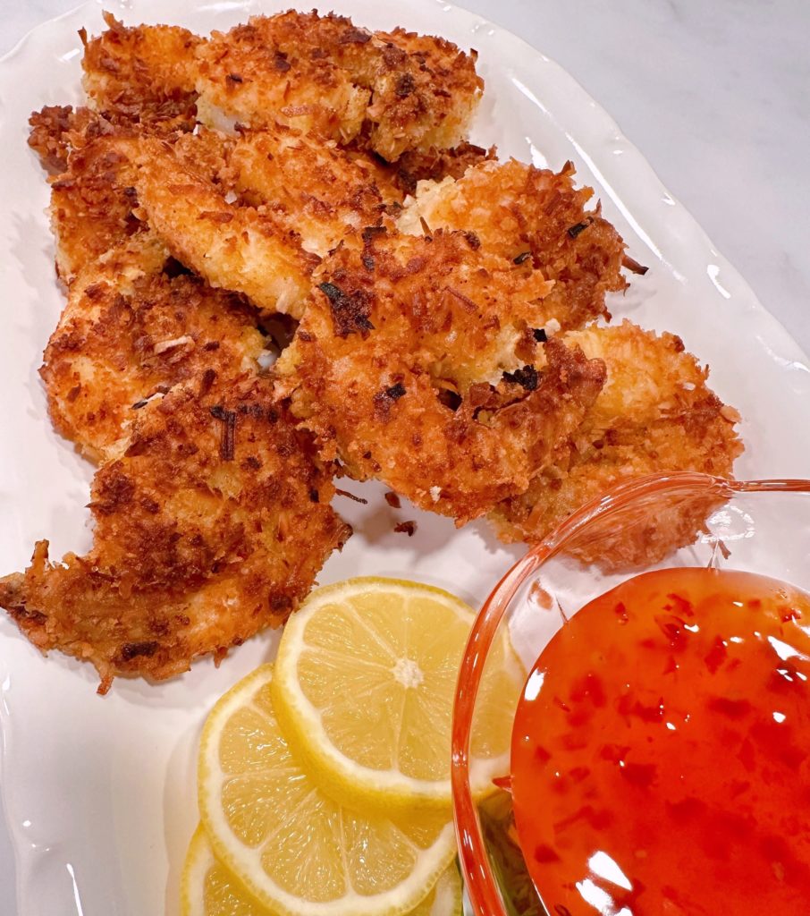 Easy Coconut Shrimp Recipe with lemon slices and dipping sauce.