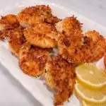 Crispy Coconut Shrimp with lemon slices.