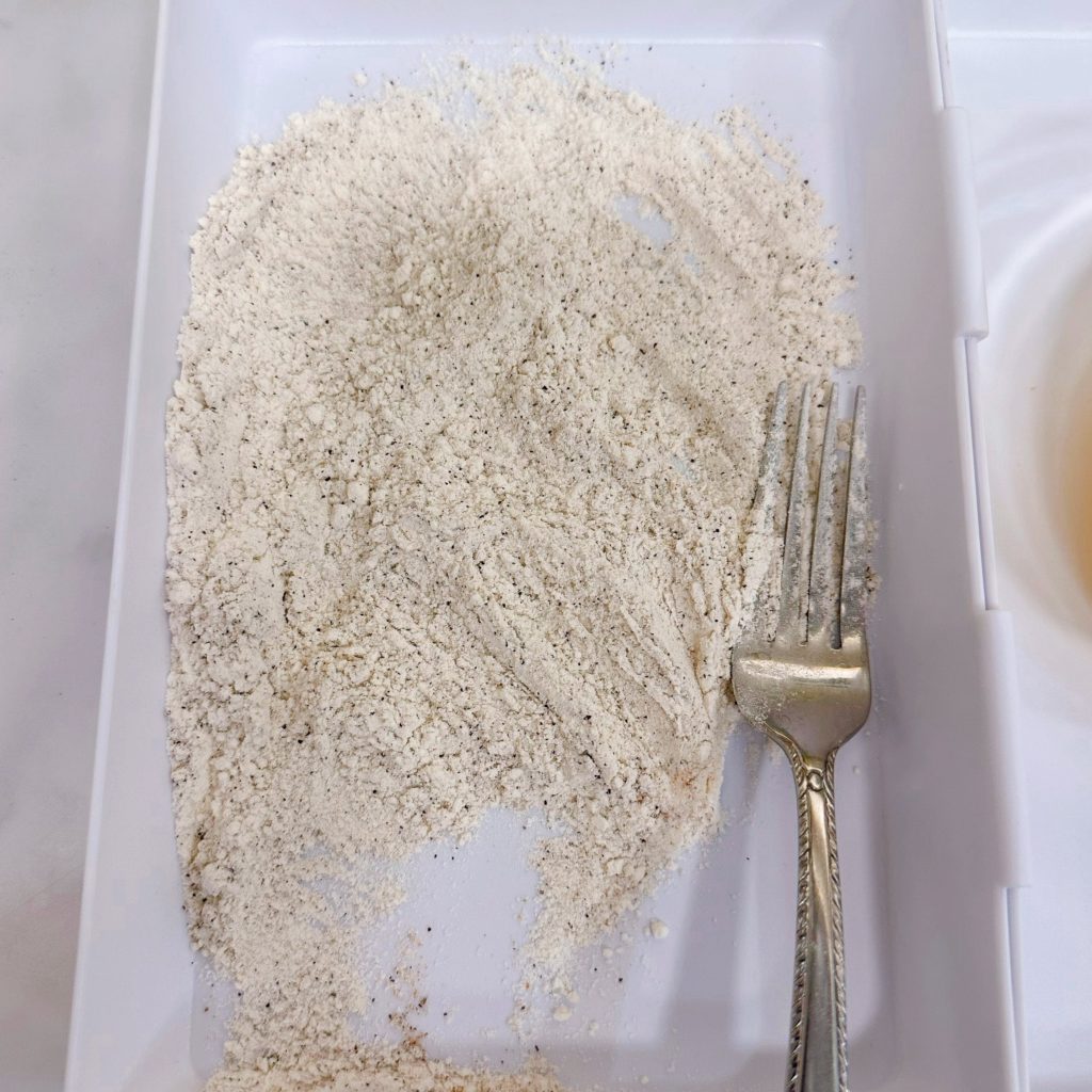 Flour and seasoning in a dredging plate.