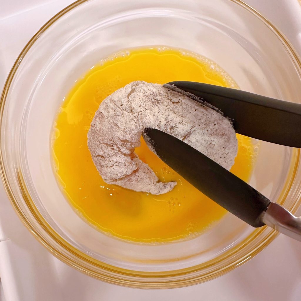 Shrimp being dipped in eggs.