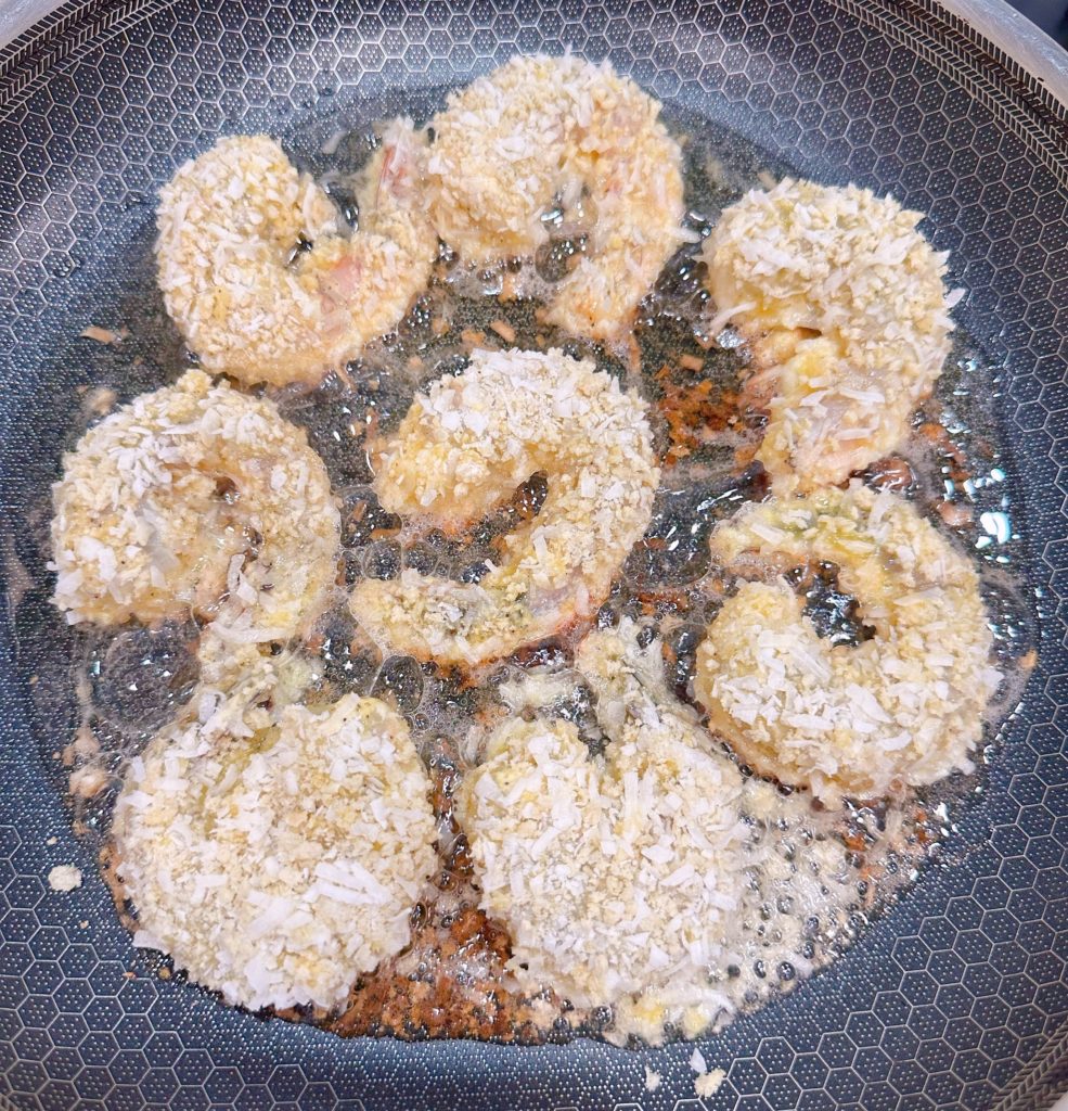 Frying shrimp in a hot skillet.