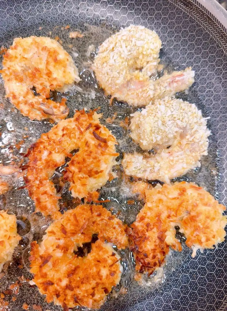 Flipping shrimp in a hot skillet.