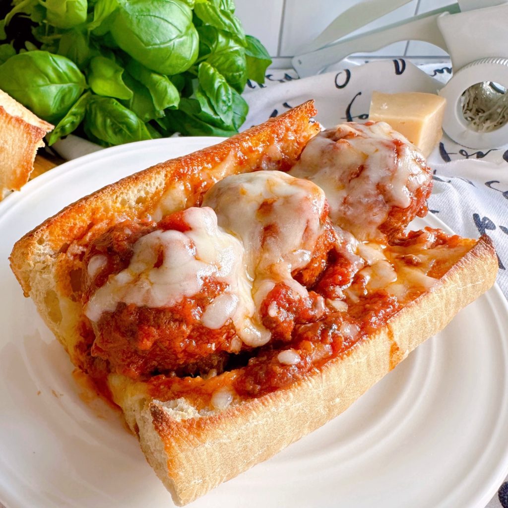 Meatball sub-sandwich up close with melthed cheese.