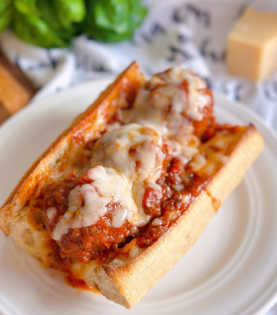 Meatball sub-sandwich up close with melted cheese.