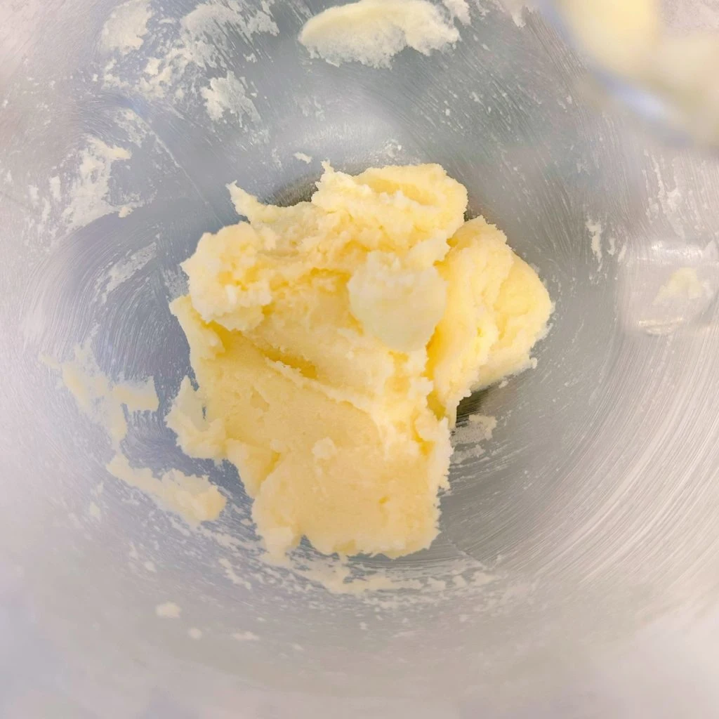 Butter and sugar are beaten together in mixing bowl.