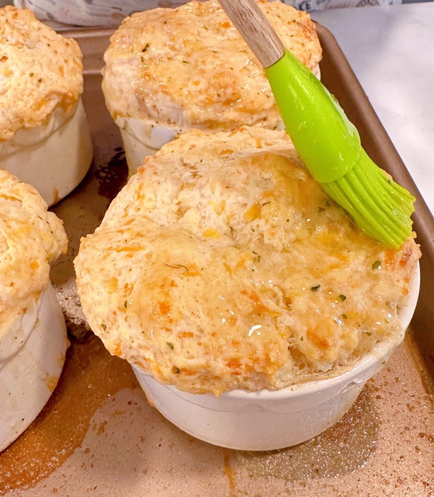 Brushing biscuits with Herbed butter.