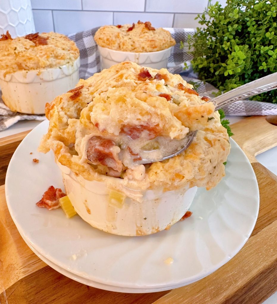 Chicken, Bacon, Cheddar Bay Biscuit Soup with a heaping spoonful lifted out of the bowl.