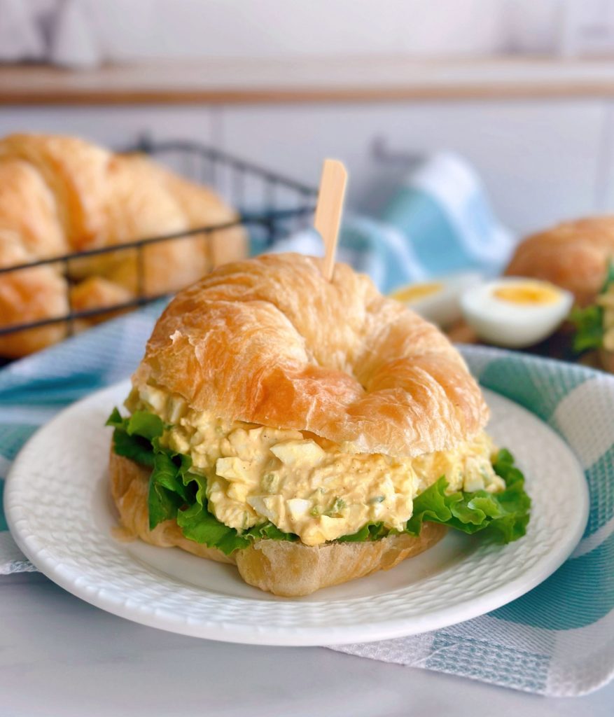 Egg Salad Sandwich on a Croissant Roll with lettuce.